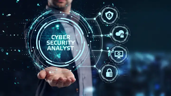 hand outstretched with icons and floating words "cybersecurity analyst" over it