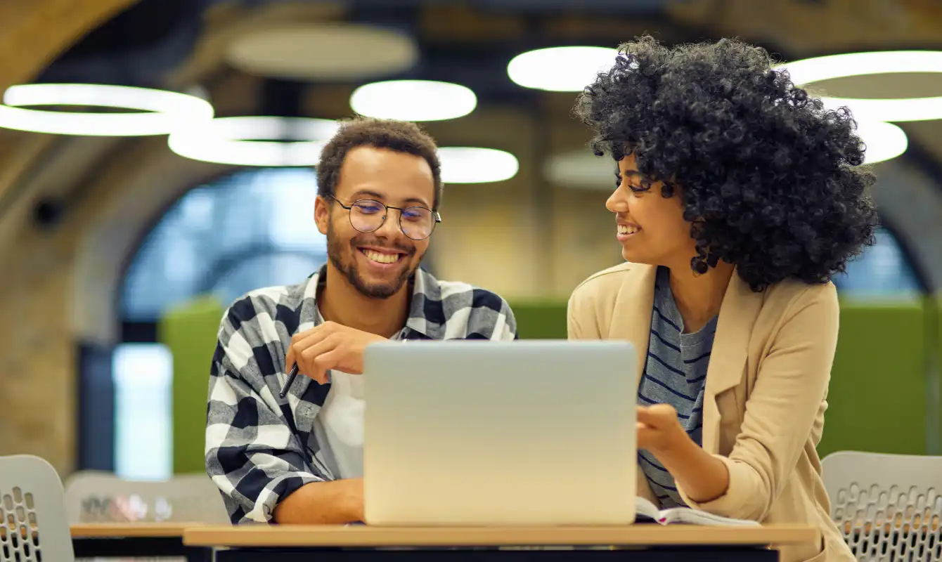 happy woman helping man using computer