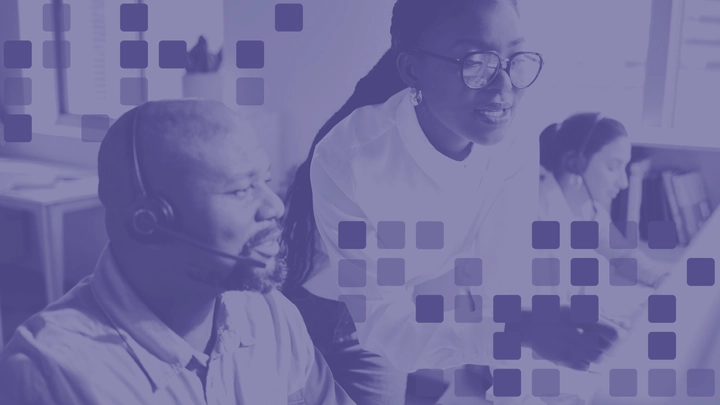 Computer support specialists assisting users in a technology support environment, representing IT jobs that can be pursued without a four-year degree.