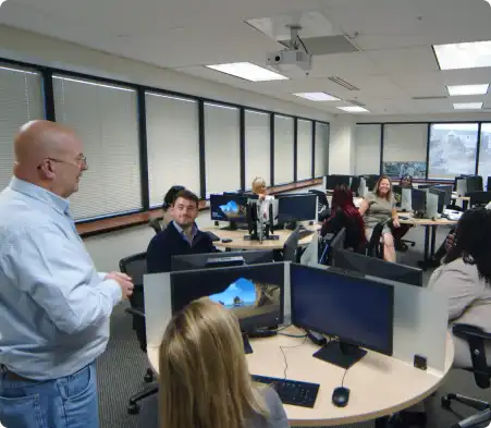 man talking in front of class of students