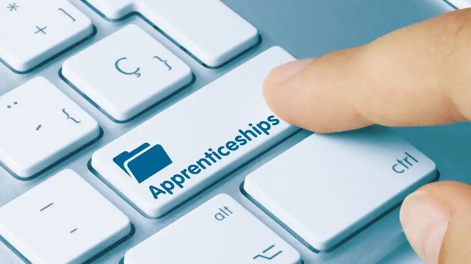 finger hitting a key that says apprenticeships on keyboard